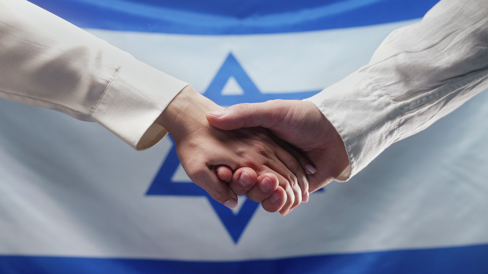 Hands Of Woman And Man Reach Out Each Other On Israeli Flag Background. Israel